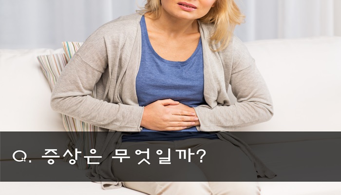 people, healthcare and problem concept - close up of unhappy woman suffering from stomach ache at home